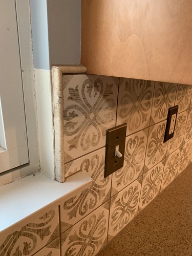 Beige tile backsplash installation